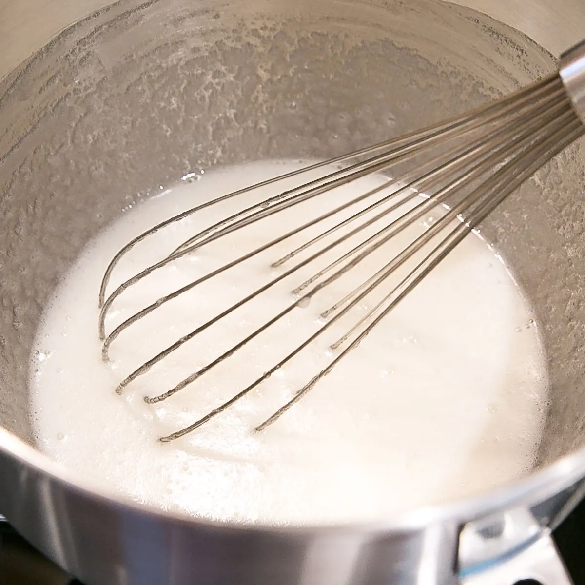 This old-fashioned 7 minute frosting recipe is light, delicious, and easy to make. A pure white frosting that's perfect for a variety of delicious desserts. | livforcake.com Egg and sugar mixture after cooking.