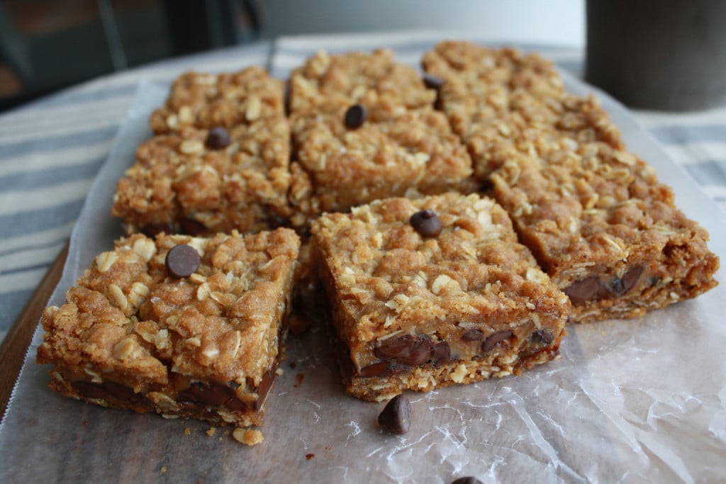 Cut up carmelita bars on parchment.