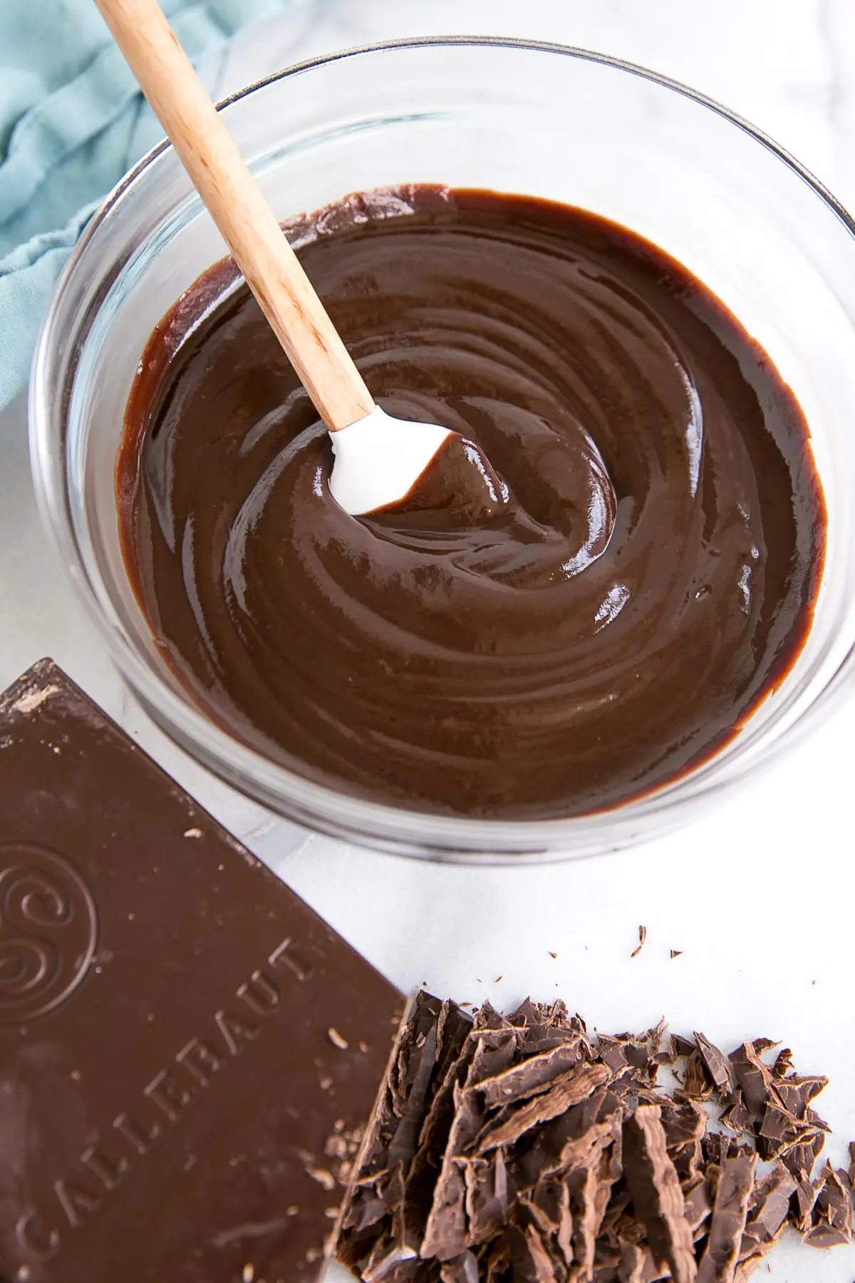 How to make Chocolate Ganache! A simple, two-ingredient recipe for a delicious frosting, filling, drip, or glaze. | livforcake.com Smooth and shiny ganache in a bowl.