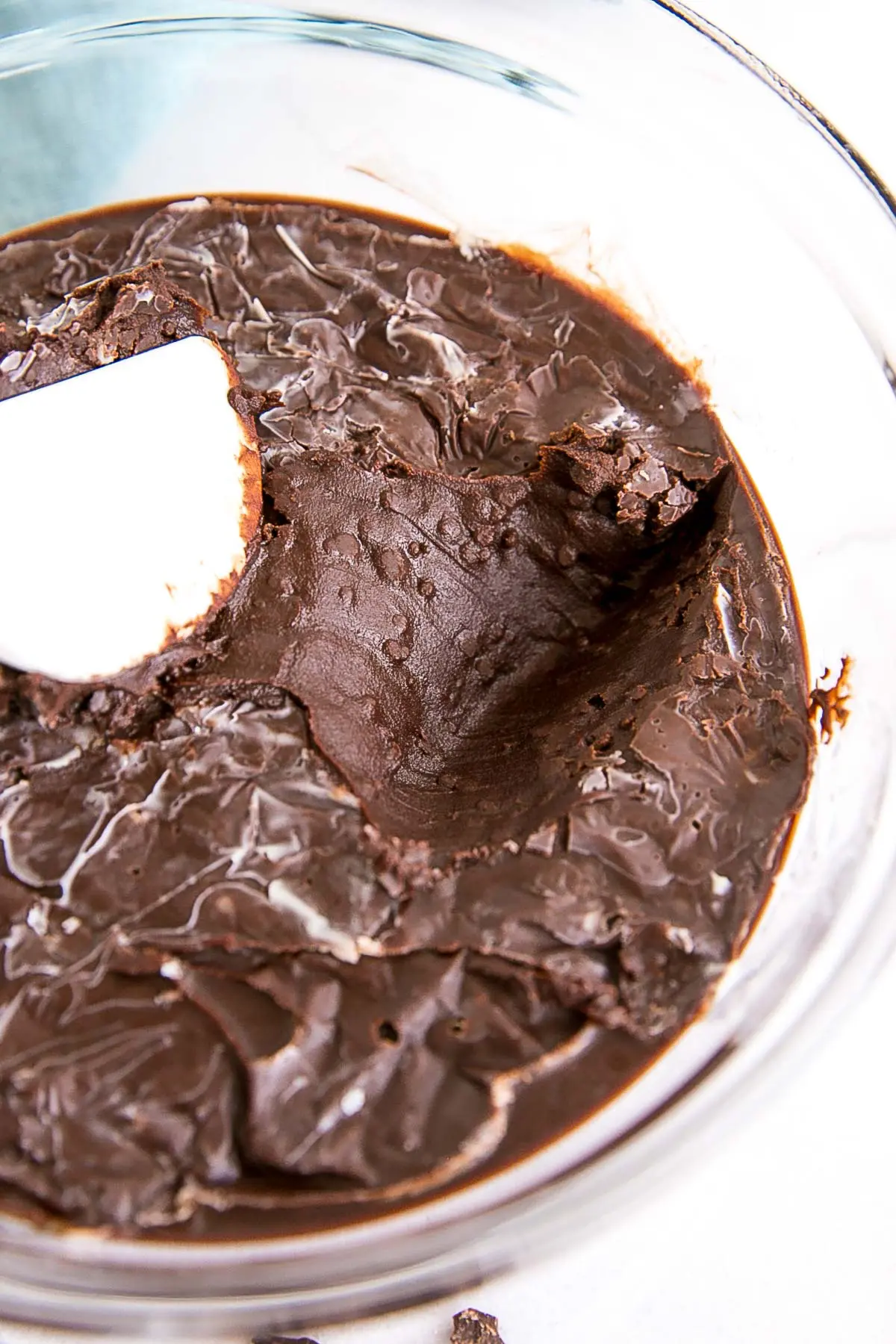 How to make Chocolate Ganache! A simple, two-ingredient recipe for a delicious frosting, filling, drip, or glaze. | livforcake.com Split ganache with chunks of solidified cocoa butter.