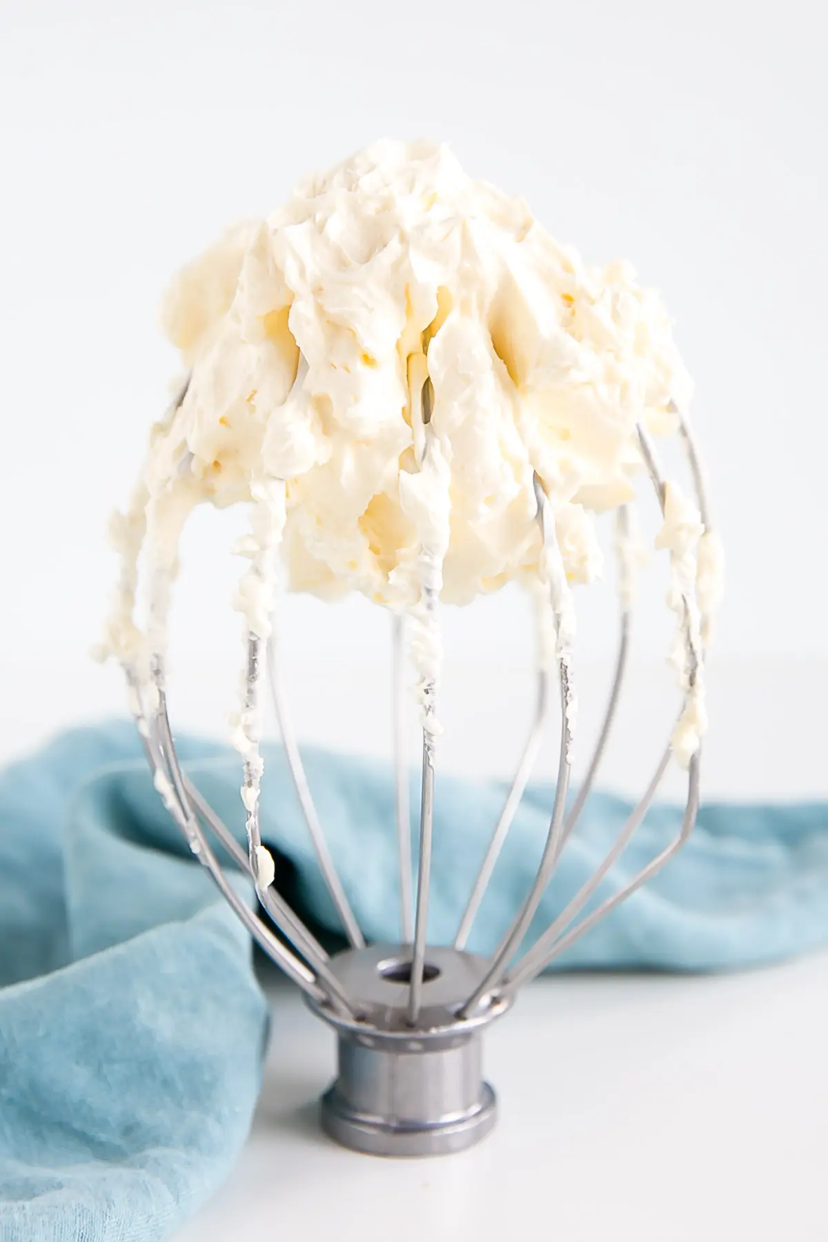 This custard-based German buttercream is made with just a few simple ingredients. Perfect for those who like a rich and silky frosting that isn't too sweet! | livforcake.com German buttercream on a whisk attachment.