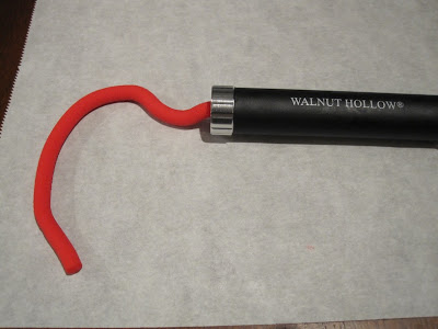 Red fondant coming out of the extruder.