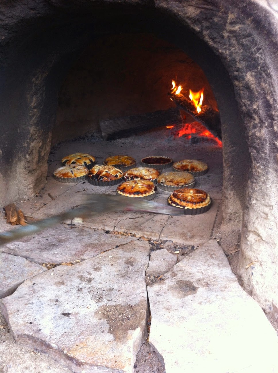 A stone cooking on a stove top oven sitting next to a fireplace