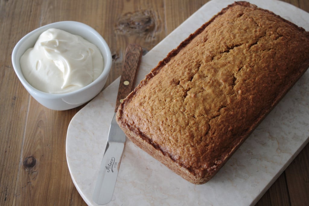Loaf on a marble slab on a wooden table.