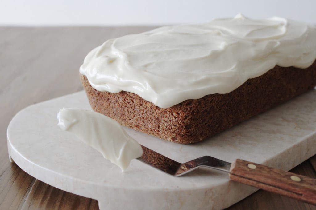 Loaf on a marble slab on a wooden table.