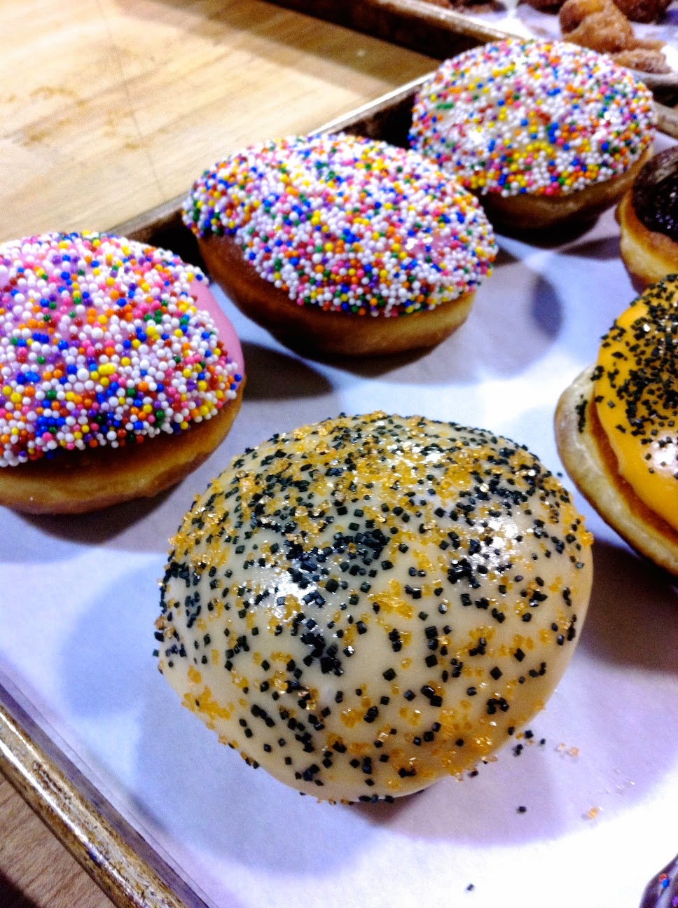 A table topped with different types of donuts on a plate