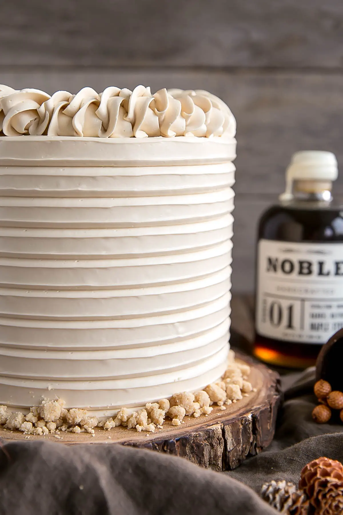 This Maple Cake is packed with pure, natural maple flavour throughout. Maple cake layers with a maple buttercream and maple streusel. | livforcake.com Close up of maple cake with maple syrup.