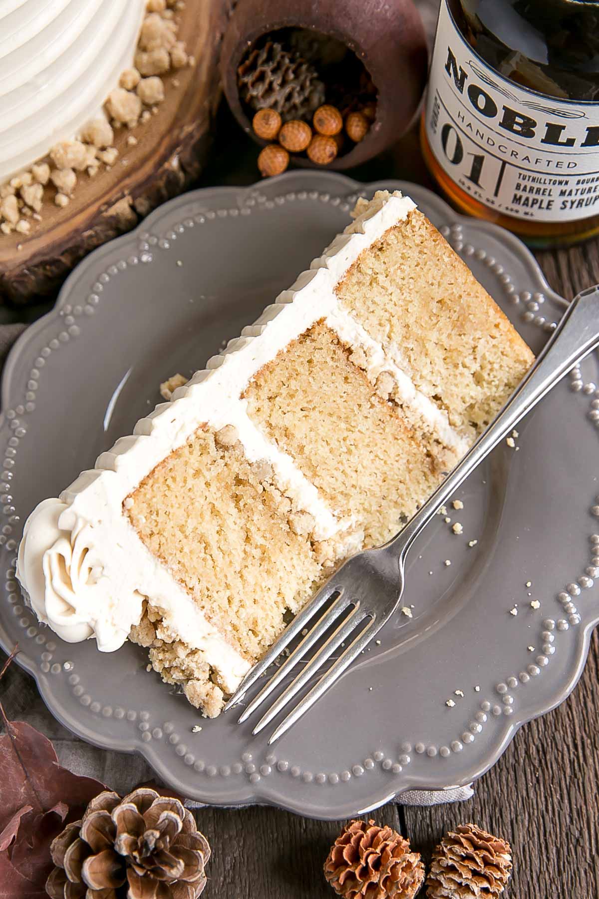 This Maple Cake is packed with pure, natural maple flavour throughout. Maple cake layers with a maple buttercream and maple streusel. | livforcake.com Slice of maple cake with maple streusel.