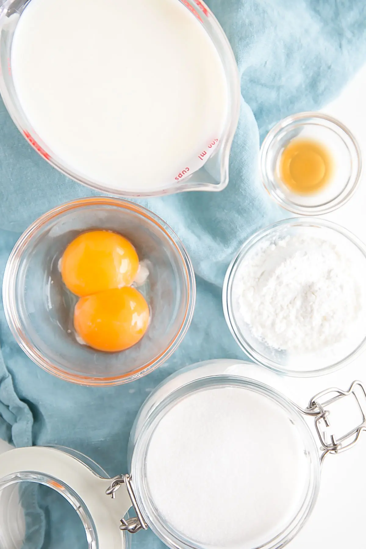 This easy Pastry Cream (Creme Patissiere) recipe is simple and delicious. A rich and creamy vanilla custard you can use in a variety of decadent desserts. | livforcake.com Picture of the ingredients needed to make vanilla custard.