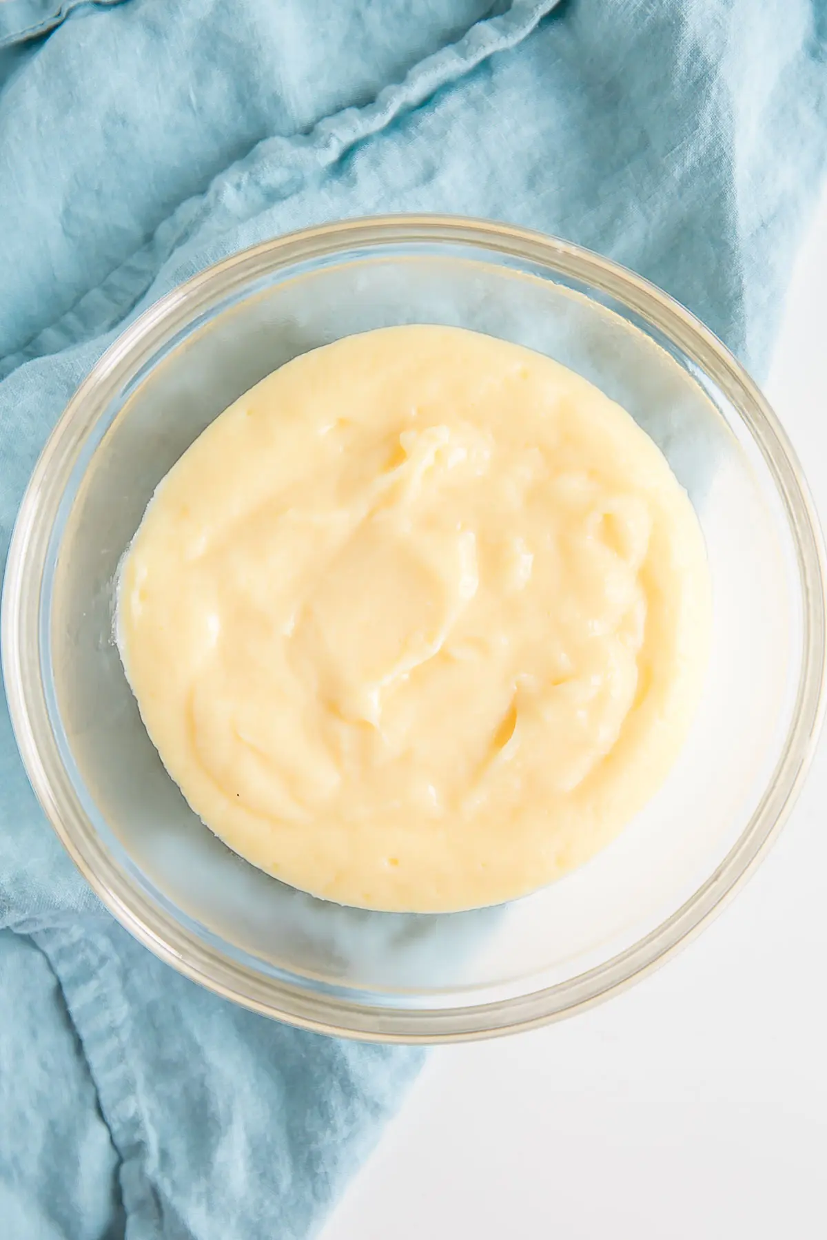 This easy Pastry Cream (Creme Patissiere) recipe is simple and delicious. A rich and creamy vanilla custard you can use in a variety of decadent desserts. | livforcake.com Creme patissiere in a bowl.
