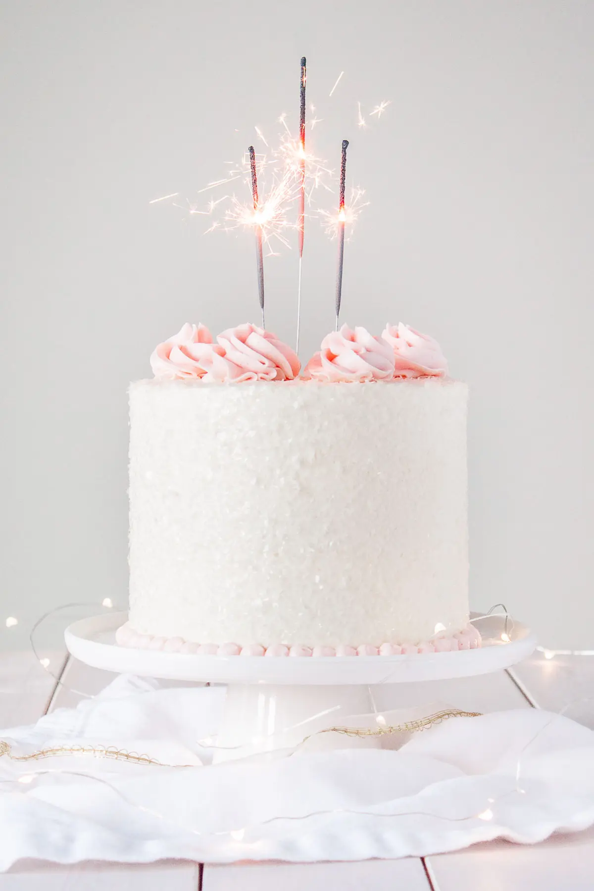 This Pink Champagne Cake is the perfect way to celebrate any occasion or holiday! A champagne infused cake with a classic vanilla buttercream. | livforcake.com A champagne infused cake with a classic vanilla buttercream.