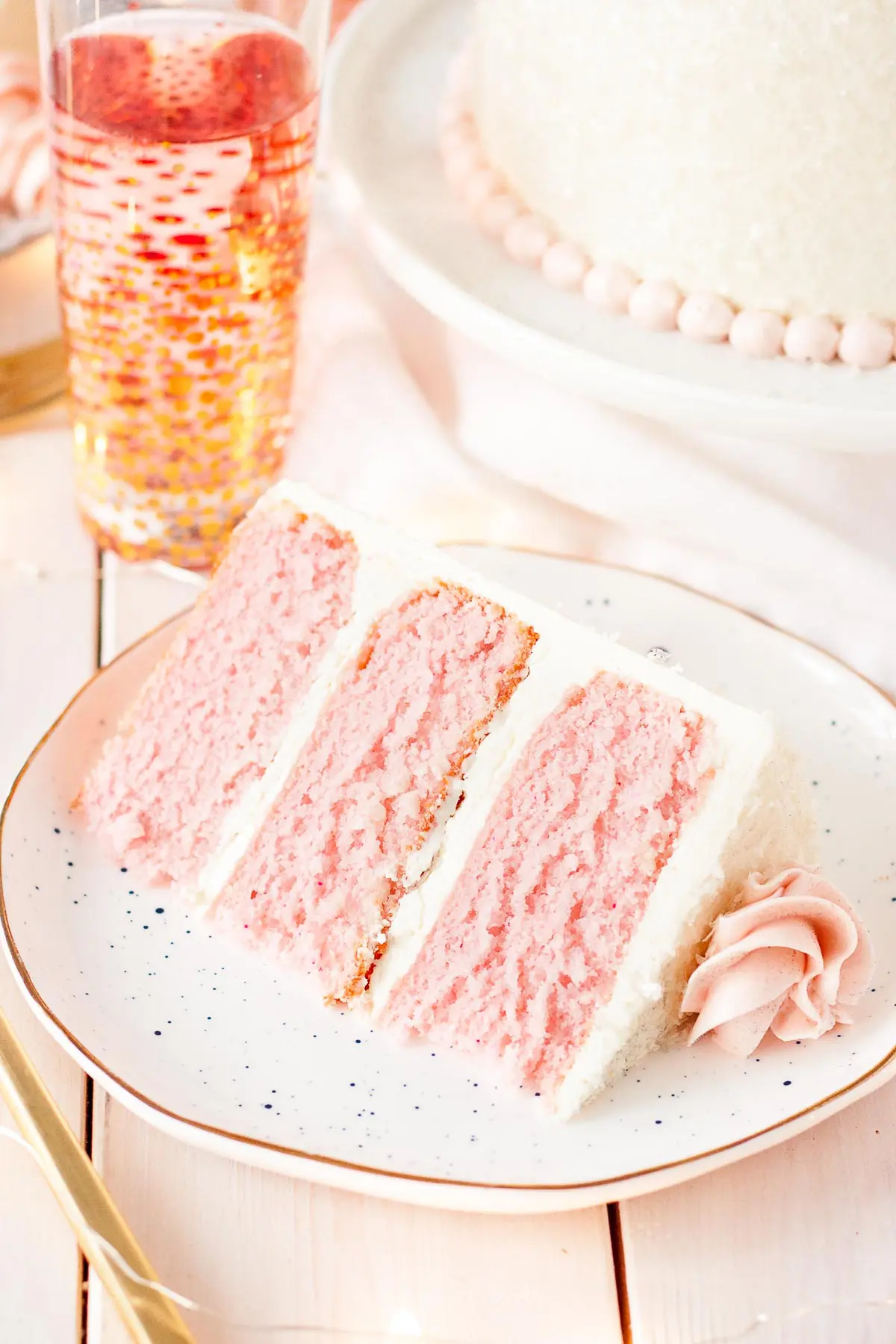 This Pink Champagne Cake is the perfect way to celebrate any occasion or holiday! A champagne infused cake with a classic vanilla buttercream. | livforcake.com Slice of Pink Champagne Cake.