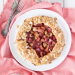 Overhead shot of the rhubarb galette on a white plate on a pink napkin.